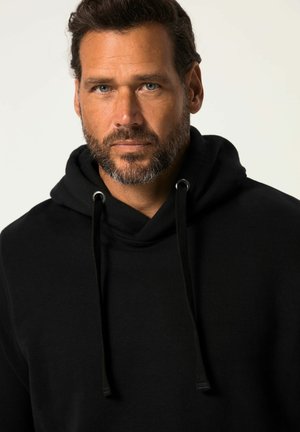 Zwarte hoodie met een kangoeroezak, koorden en een zachte textuur. De stof lijkt dik, wat warmte en comfort biedt.