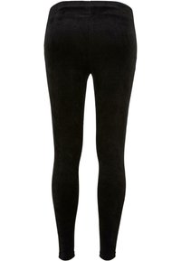 Leggings en velours côtelé noir avec une texture lisse, un design ajusté et des jambes effilées, présentant une taille haute et sans hardware visible.
