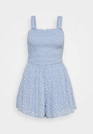 Lichtblauwe romper met kleine witte bloemenprint. Voorzien van een gerimpelde bovenkant, verstelbare bandjes en uitlopende korte broek. Zachte, gestructureerde stof.