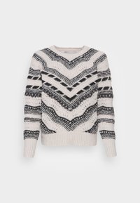 Pull en maille crème avec motifs zigzag et rayures noirs, manches longues, et poignets et ourlet côtelés.
