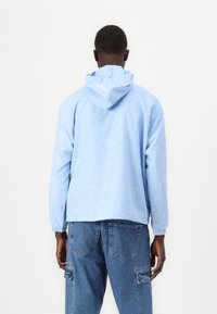 Lacoste Ľahká bunda - light bleu