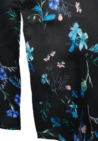 Black fabric featuring a floral pattern, with blue, pink, and green flowers. Smooth texture, slightly shiny surface, short sleeves visible.