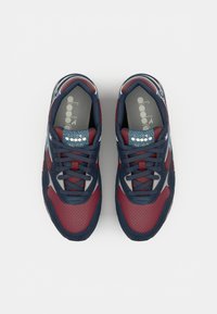 Red and navy athletic shoes with mesh panels and gray accents, displayed from above on a white background.