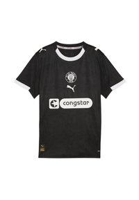 Sort fodboldtrøje med hvide detaljer, prydet med et blomsterdesign, med FC St. Paulis logo, Puma-logo og "congstar" tekst på forsiden.