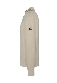 Helle beige Strickpullover mit hohem Kragen, gerippten Bündchen und seitlichem Reißverschluss. Auf dem linken Ärmel befindet sich ein kleines schwarzes Logo.