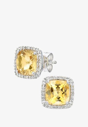 Dzeltens dārgakmens auskari ar kvadrāta formu, apņemti ar mazām caurspīdīgām kristāliem. Sudraba toņa metāla uzlikums ar pulētu virsmu.