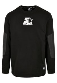 Sweat-shirt noir à manches longues avec logo blanc "Starter" et étoile sur la poitrine, coudières noires renforcées et poignets côtelés.