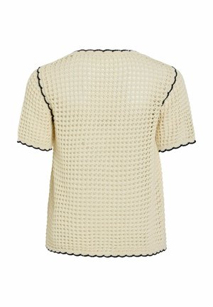 Krém színű, rövid ujjú, gofrés kötött felső fekete hullámos szegéllyel az ujjakon, a nyakrészen és az alján, hátulnézetből.