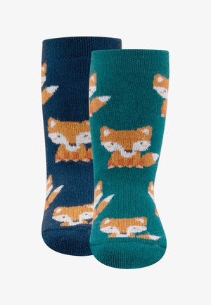 Paire de chaussettes pour enfants, une bleu foncé et une turquoise, chacune ornée de motifs de visages de renard orange et blanc.