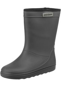 Botte de pluie en caoutchouc noir avec une finition lisse, une semelle texturée et une garniture élastiquée noire en haut. Présente une petite étiquette argentée.