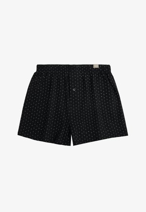 Boxer negros de hombre con pequeños patrones de rayas verticales en blanco y gris y una cintura elástica con una pequeña etiqueta de la marca.