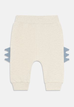 Beige babyskjørt med ribbestrikket linning og mansjetter, med blå dinosaurtopper på sidene.