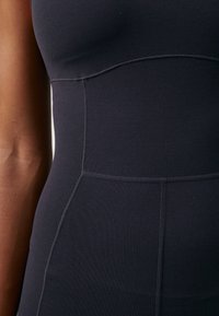Nike Performance ZENVY WOMENS DRI FIT FULL LENGTH FLARED BODYSUIT - Gimnastički dres - black/(pcg6c)
