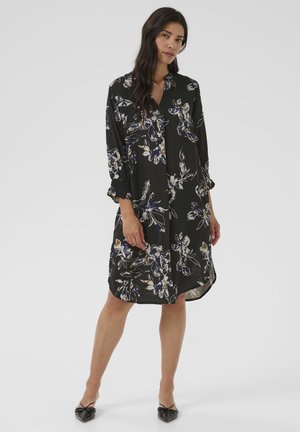 Schwarzes Kleid mit floralem Muster in Lila und Creme. Mit V-Ausschnitt, langen Ärmeln mit gerafften Manschetten und saumlanger Länge bis zum Knie.