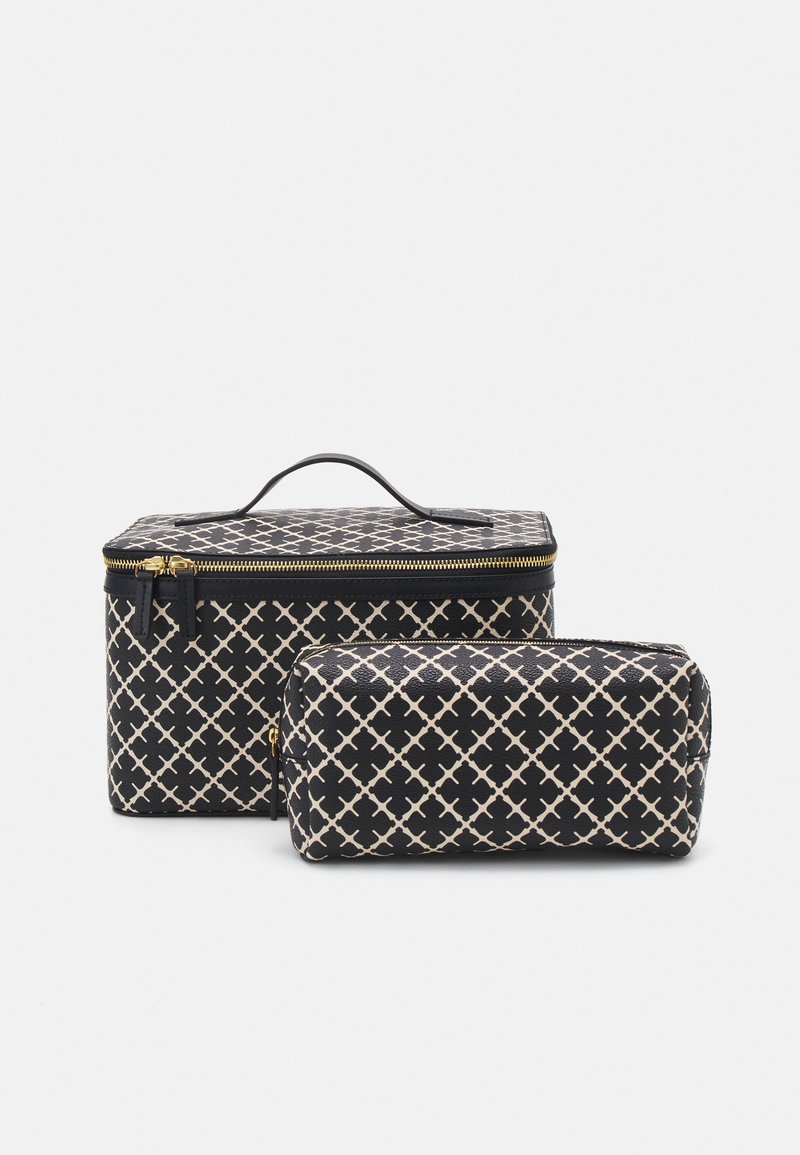 Two patterned bags, one rectangular with a handle and gold zipper, the other cylindrical, both in black with cream geometric designs.