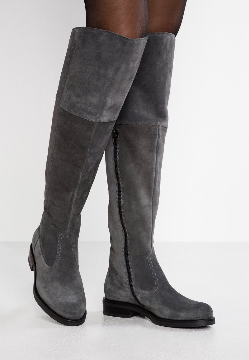 Gray suede over-the-knee boots with a smooth texture, side zipper, and flat heel, featuring a contrasting lighter gray panel design.