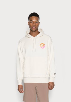 Cream-colored hoodie with a front pocket, drawstring hood, and a colorful graphic logo on the chest. Soft fabric, relaxed fit.