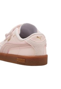 Las zapatillas Puma presentan una parte superior sintética de color rosa claro con un talón de ante, una suela de goma y acentos dorados del logo en los lados y en la parte trasera.