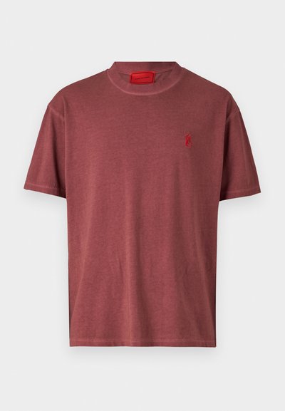 Camiseta de manga corta y cuello redondo hecha de una suave tela burdeos, que presenta un pequeño logo de llama roja en el área del lado izquierdo del pecho.