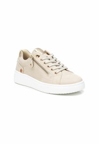 Zapatilla beige con parte superior de cuero suave, suela de goma blanca, cremallera metálica decorativa y cordones grises. Presenta una forma de punta redonda.