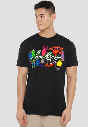 Black cotton t-shirt featuring colorful Jim Henson characters and text in bright green, arranged across the front. Crew neck design.