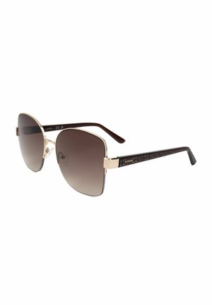 Occhiali da sole quadrati con montatura in metallo dorato, lenti scure sfumate e aste nere decorate con piccolo logo dorato Guess.