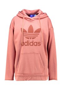 Růžová bavlněná mikina s kapucí, přední kapsou a oversize střihem. Obsahuje velké kontrastní logo uprostřed.