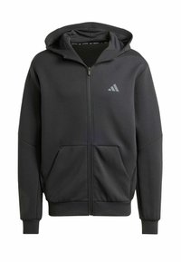 Hoodie noir zippé en tissu doux, avec une poche avant, capuche à cordon et un logo gris sur le côté supérieur gauche.