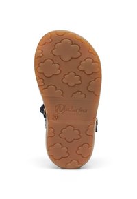 Gumová podešev s květinovým vzorem, světle hnědé barvy, s vyraženým logem. Povrch je hladký s zaoblenými tvary a texturovanými úchyty.
