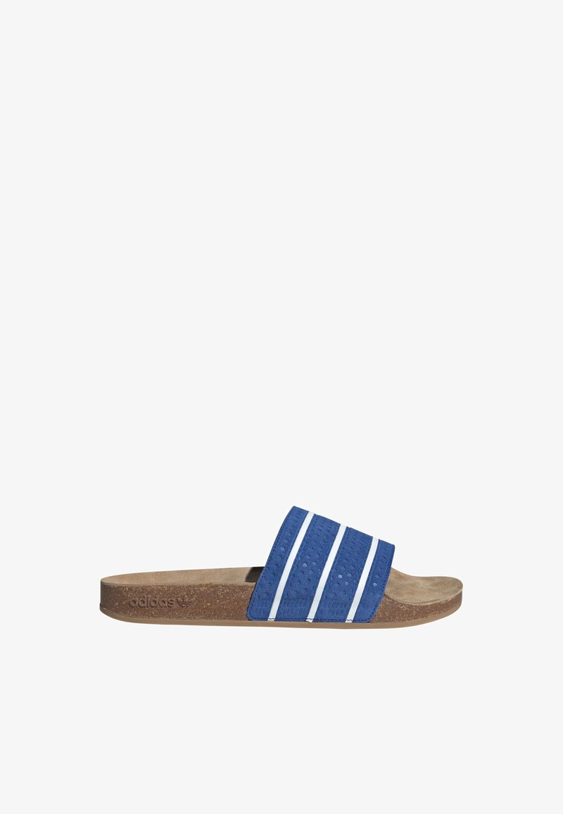 Blue slide sandal with textured upper featuring three white stripes, cork footbed, and rubber outsole. Lightweight and open design.