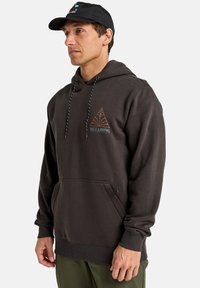 Dark gray hoodie with a front pocket, adjustable drawstring hood, and a triangle graphic featuring the text "BILLABONG" in teal and bronze.