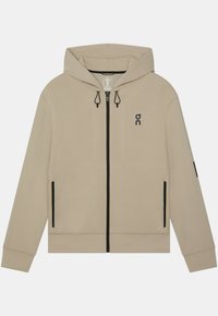 Sweat à capuche beige avec fermeture éclair noire et détails des poches, une capuche avec cordons et un petit logo noir sur la poitrine gauche.