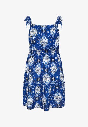 Blauwe mouwloze zonnejurk met wit en zwart bloemen paisley patroon en gestrikte schouderbandjes.