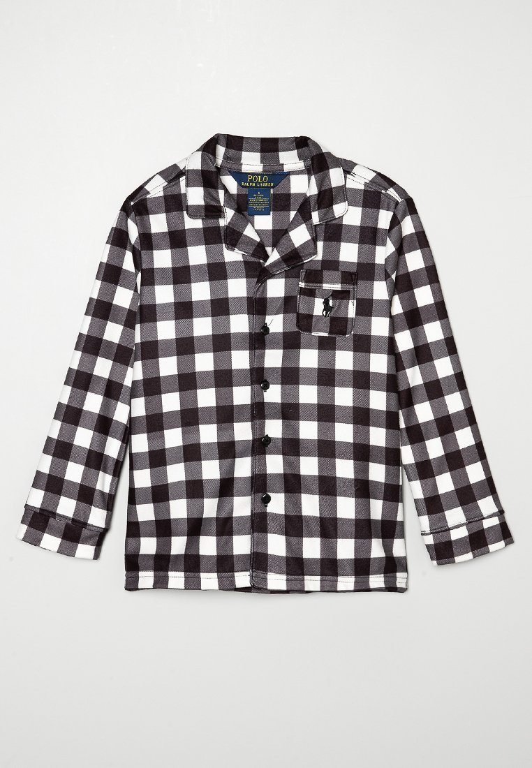 Chemise en flanelle à carreaux noir et blanc avec manches longues, poche poitrine, col et fermeture à boutons sur le devant. Fabriquée en tissu doux et texturé.