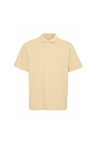 Beige polo-skjorte i bomullsmateriale med klassisk krage, tre-knaps knappestolpe, korte ermer og en avslappet passform.