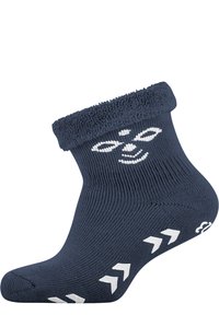 Mörkblå strumpa med en frottékant, prydd med ett vitt tryckt ansiktsmönster och vita pilmönster längs botten. Tillverkad i ribbad textur.