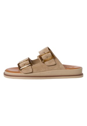 Light tan suede slide sandal featuring two large brown buckle accents, a smooth beige outsole, and a cushioned insole.