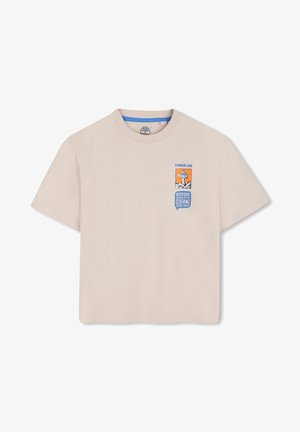 Beige short-sleeve cotton t-shirt featuring a graphic design with "Timberland" and "OUTDOOR INSPIRED CLOTHING" in blue and orange.