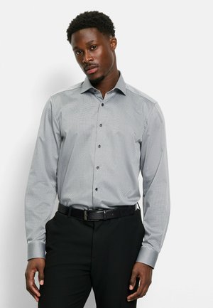 Gray patterned dress shirt with a pointed collar, long sleeves, and button-down front. Worn with black trousers and a black belt.