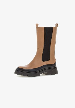 Tan leather ankle boot with black elastic side panels, rubber sole, and a chunky heel. Features a smooth texture and round toe design.