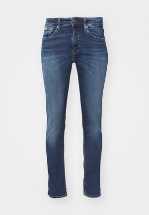 Dunkelblaue Jeans aus Denim mit Slim-Fit, fünf Taschen, einem Knopfverschluss und dezenten Ausbleichungen an Oberschenkeln und Knien.