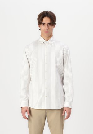 Menns skjorte med knapper i hvit med lysebeige striper. Har krage, lange ermer og rette mansjetter. Laget av glatt stoff.