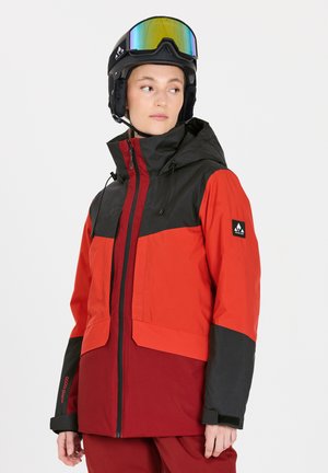 Rote und schwarze Skijacke mit durchgehendem Reißverschluss, verstellbarem Kapuze und kontrastierenden Ärmeln. Verfügt über ein Logo auf der Schulter und strukturierter Stoff.