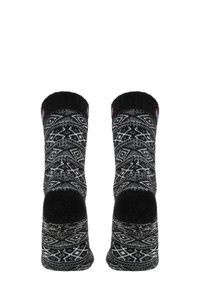 Schwarz-weiß gemusterte Socken mit einem geometrischen Design, einem kontrastierenden schwarzen Bündchen sowie verstärkten Fersen- und Zehenbereichen.