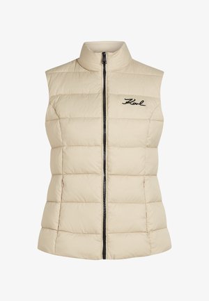 Bežna brezrokavna pufastka brez rokavov z visokim ovratnikom, zadrgo in črnimi vezeninami "Karl" na prsih. Celotna tekstura je kviltana.