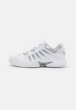 White athletic shoes with gray accents, textured mesh panels, ventilation perforations, and a distinctive sole design for traction.