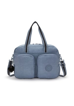 Blue nylon duffel bag with two front zip pockets, striped handles, adjustable shoulder strap, and a small plush keychain accessory.