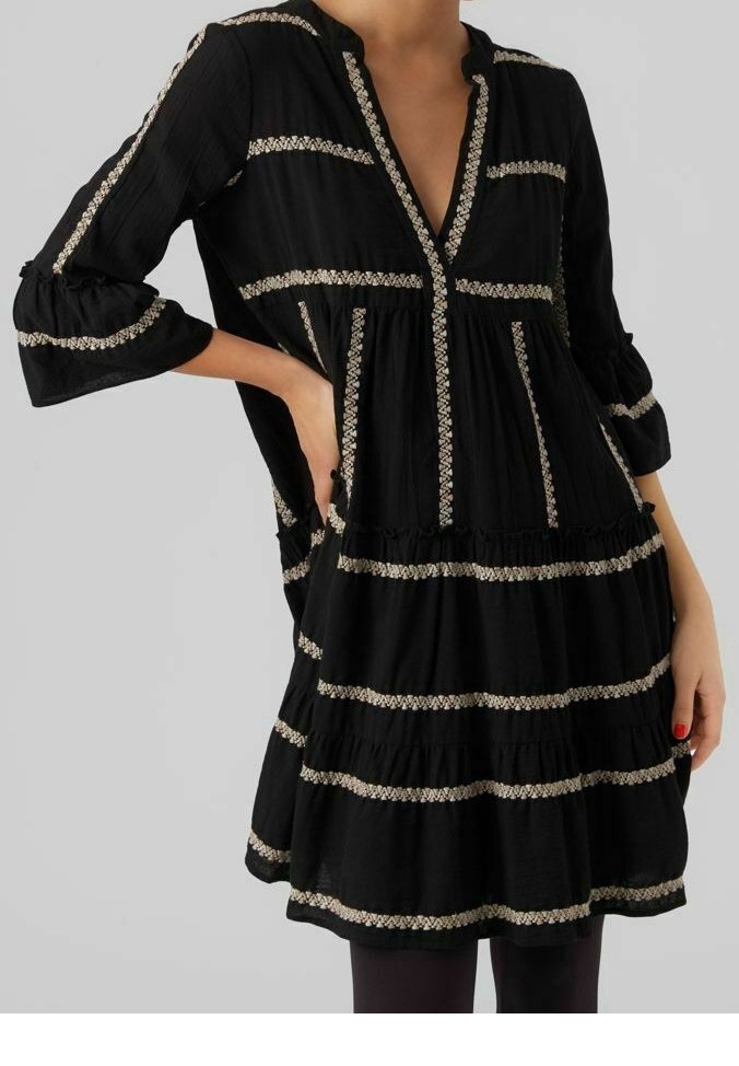 Black dress with three-quarter sleeves, featuring a deep V-neck and textured striped gold embellishments. Flowy tiered design.
