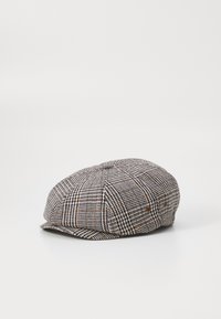 Newsboy cap in houndstooth pattern. Made from woven fabric, featuring a rounded top, small brim, and two side vents with brown accents.