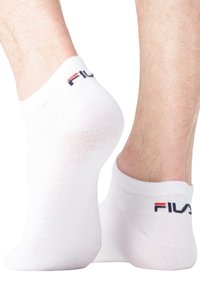 Chaussettes blanches mi-mollet en tissu doux et extensible, avec un bord côtelé et un accent de logo rouge et bleu au dos.